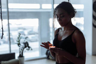 young woman lighting a candle.weekend reset. weekend reset routine. wellness retreat. Bedroom retreat ideas. wellness retreat. home retreat ideas. Refreshed. self care weekend. self care weekend ideas. how to have a self care weekend. 