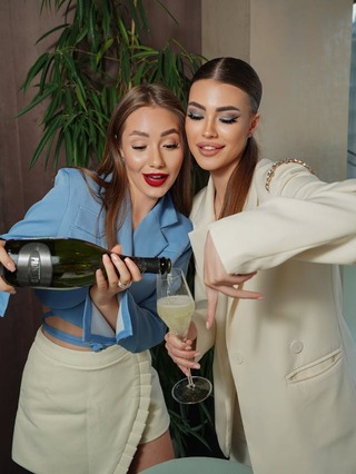 2 girls at a party pouring champagne. galentines dinner ideas. February 13th. galentines day ideas. when is galentines day. girls night cocktails. girls night dinner ideas. girls night snack ideas. girls night in ideas.what to do for girls night. what to do on a girls night. Girl dinner.