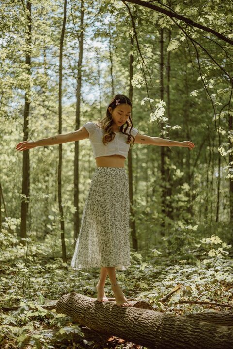 carefree young woman barefoot in a forest. 