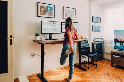 woman at standing office desk. 