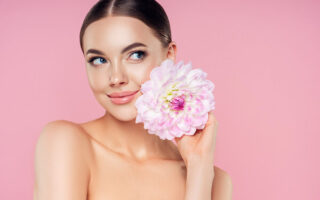 Beautiful woman with flowers. Best pore minimizing primer. What does primer do for makeup. can i use primer without makeup. different types of primer makeup. what does primer do. what is primer. what is primer used for. how to apply primer.