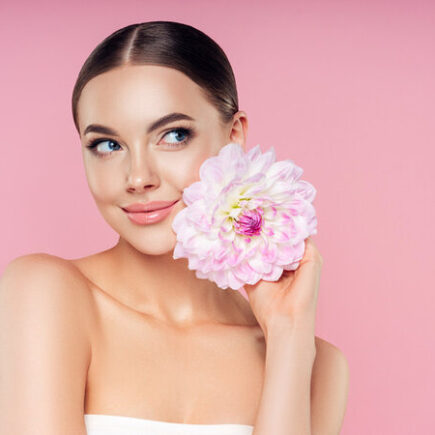 Beautiful woman with flowers. Best pore minimizing primer. What does primer do for makeup. can i use primer without makeup. different types of primer makeup. what does primer do. what is primer. what is primer used for. how to apply primer.