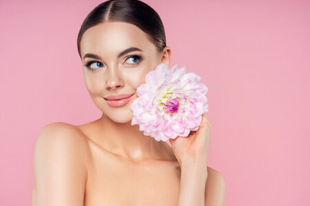 Beautiful woman with flowers. Best pore minimizing primer. What does primer do for makeup. can i use primer without makeup. different types of primer makeup. what does primer do. what is primer. what is primer used for. how to apply primer.