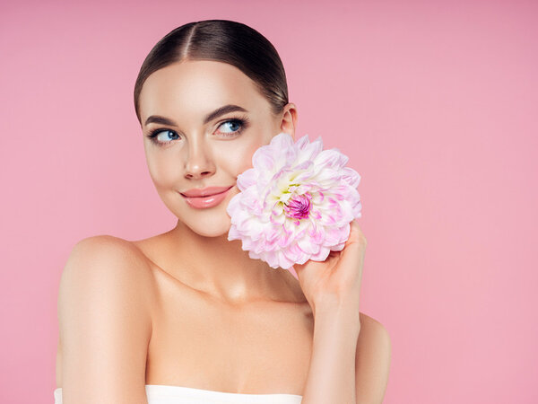 Beautiful woman with flowers. Best pore minimizing primer. What does primer do for makeup. can i use primer without makeup. different types of primer makeup. what does primer do. what is primer. what is primer used for. how to apply primer.