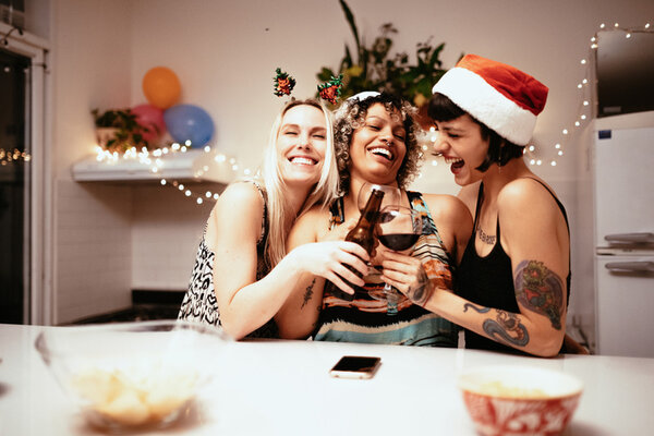 Young Latina women having a party or Christmas party. Christmas girls night. Christmas party. Christmas ladies night. holiday girls night. Christmas cocktails. girls night in. holiday party theme. ugly sweater party. 