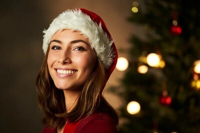 Portrait of a woman wearing a christmas hat. She us happy. Chritmas tree in the background. Surviving Christmas. Self care and how to glow up. New Years Eve.